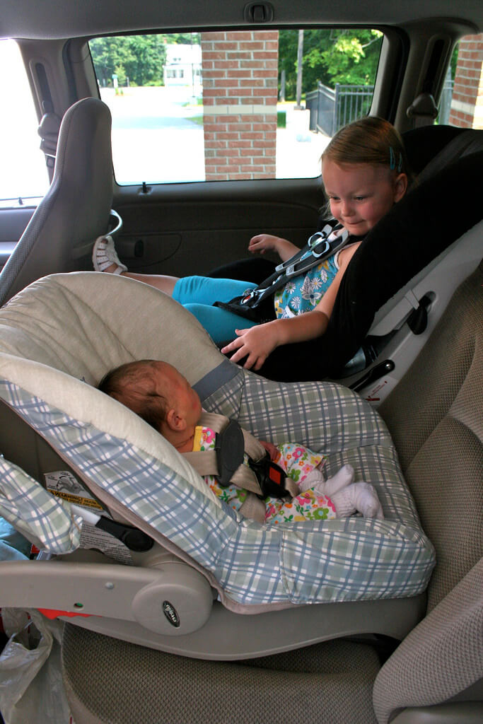Kid strapped on a car seat