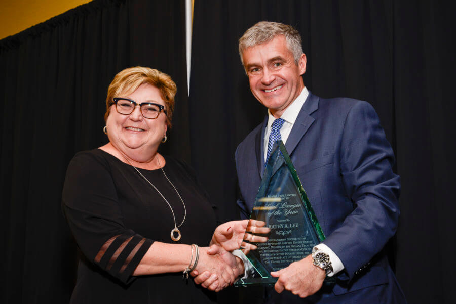 Man and woman holding an award